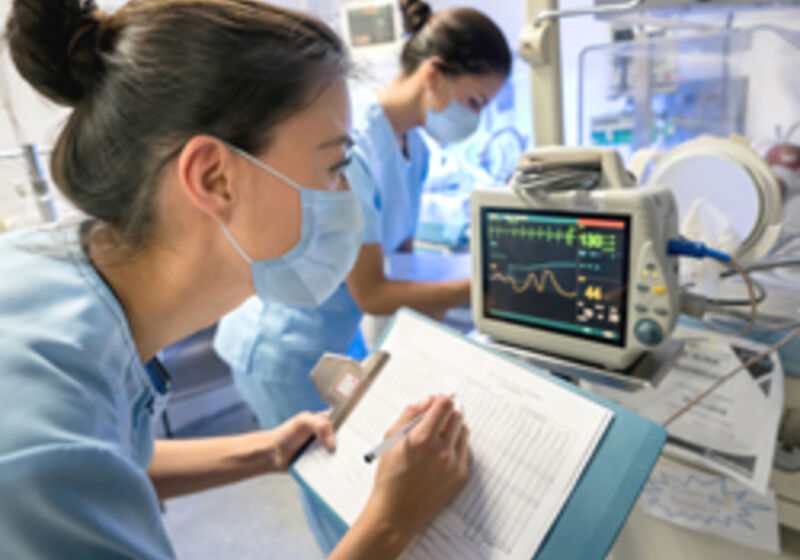 Two nurses in a neonatal care unit