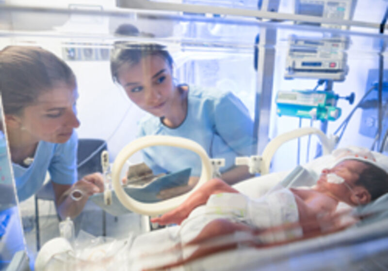 Two nurses caring for a baby