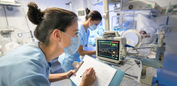 Nurses reading monitors